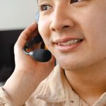 Agente de atendimento fala ao telefone usando um headset em um ambiente de central de suporte