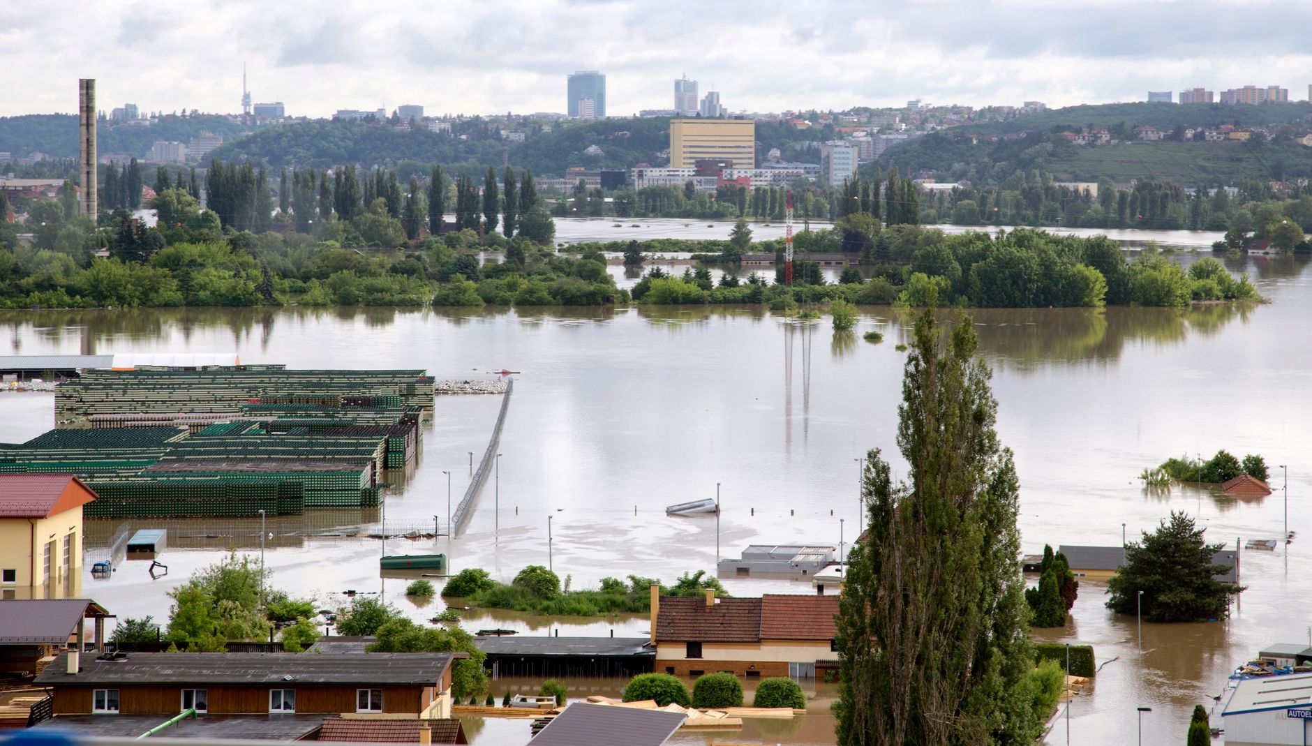 Vista aérea de uma cidade com ruas e construções parcialmente submersas por águas de enchente.